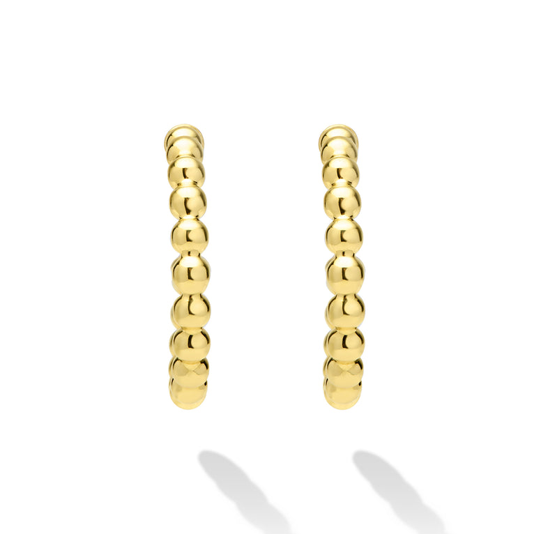 Gold hoop earrings on a white background