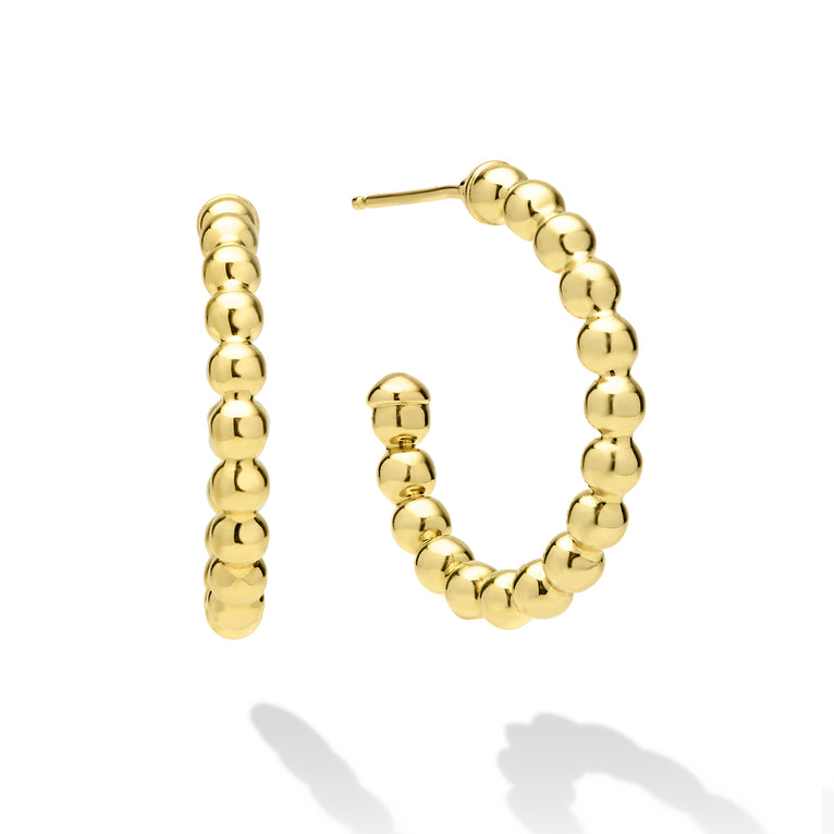 Gold hoop earrings on a white background