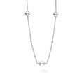 Silver necklace with three spherical beads on a white background
