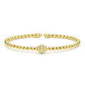 Gold beaded bracelet with a clasp on a white background