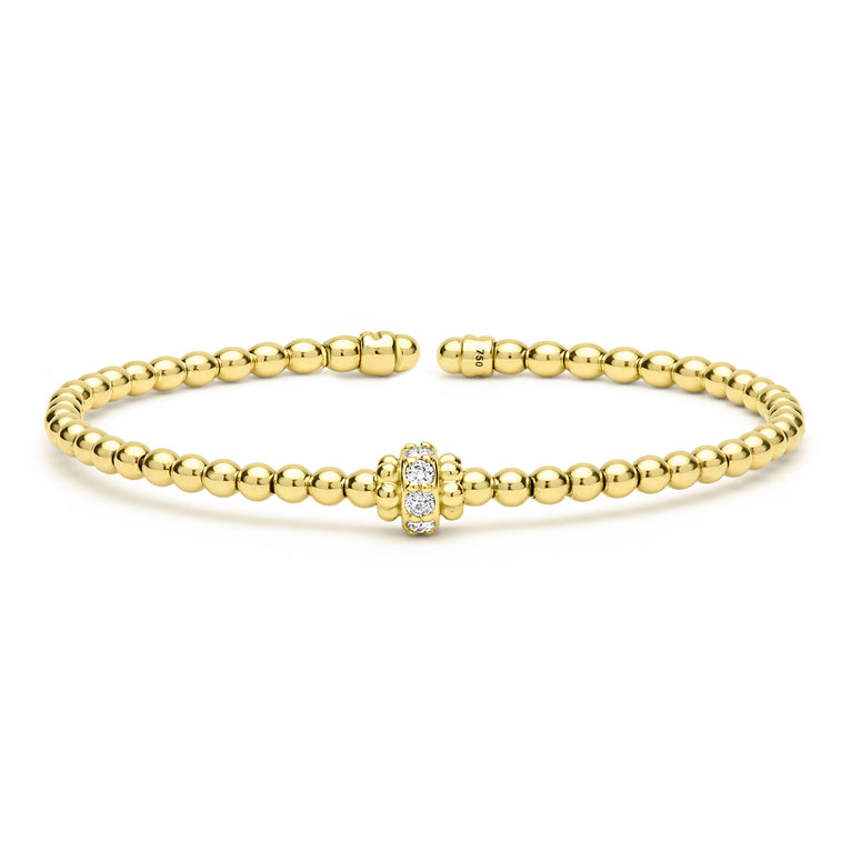 Gold beaded bracelet with a clasp on a white background