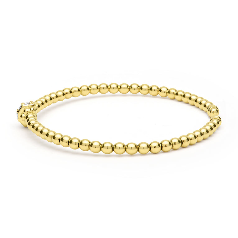 Gold beaded bracelet on a white background