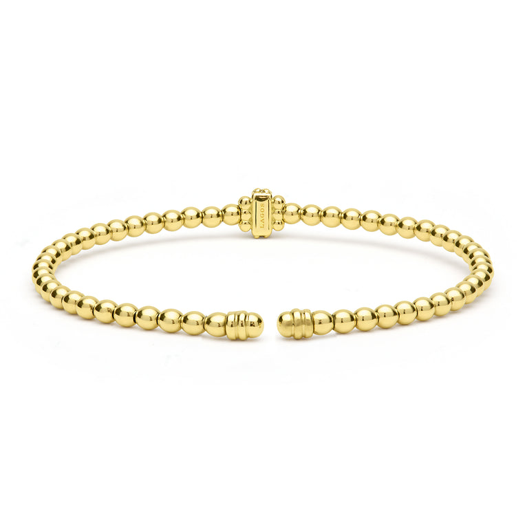 Gold beaded bracelet on a white background