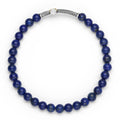 Blue beaded bracelet with a silver and gold cross charm on a white background