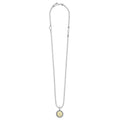 Signature Caviar V Initial Charm Necklace featuring a sterling silver chain, 18K gold V charm with caviar beading, and a LAGOS engraved tag.