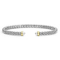 Silver bracelet with gold accents on a white background
