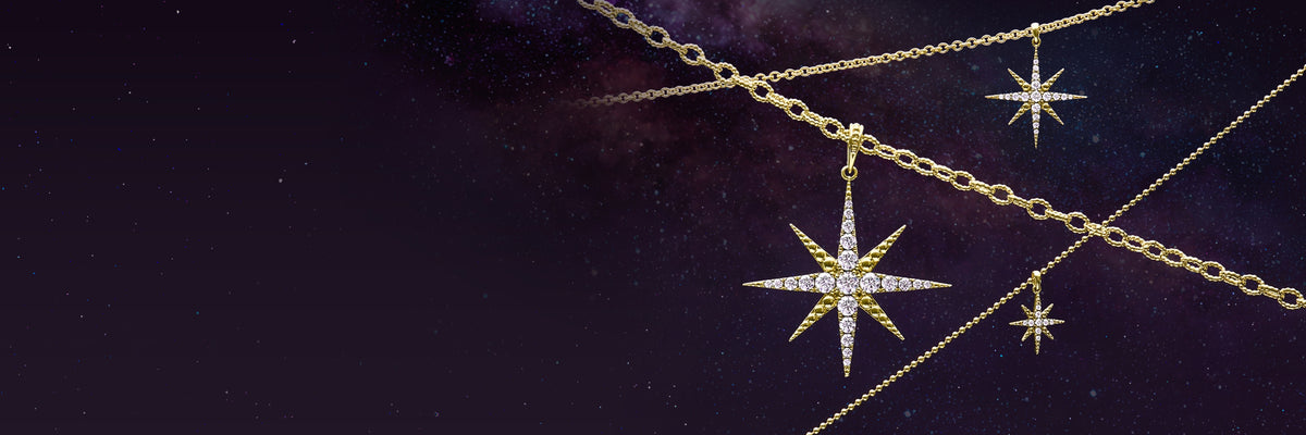 Gold starburst pendant necklaces with diamonds, displayed on a dark starry space background.