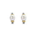 Luna Two-Tone Pearl Huggie Earrings feature a large white pearl on a sterling silver and 18K gold beaded band, embodying LAGOS's elegant craftsmanship.