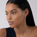 model wearing Swiss Blue Topaz huggie earings