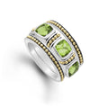 A trio of stacking rings with one peridot ring and two 18K gold Caviar beaded rings with sterling silver accents.