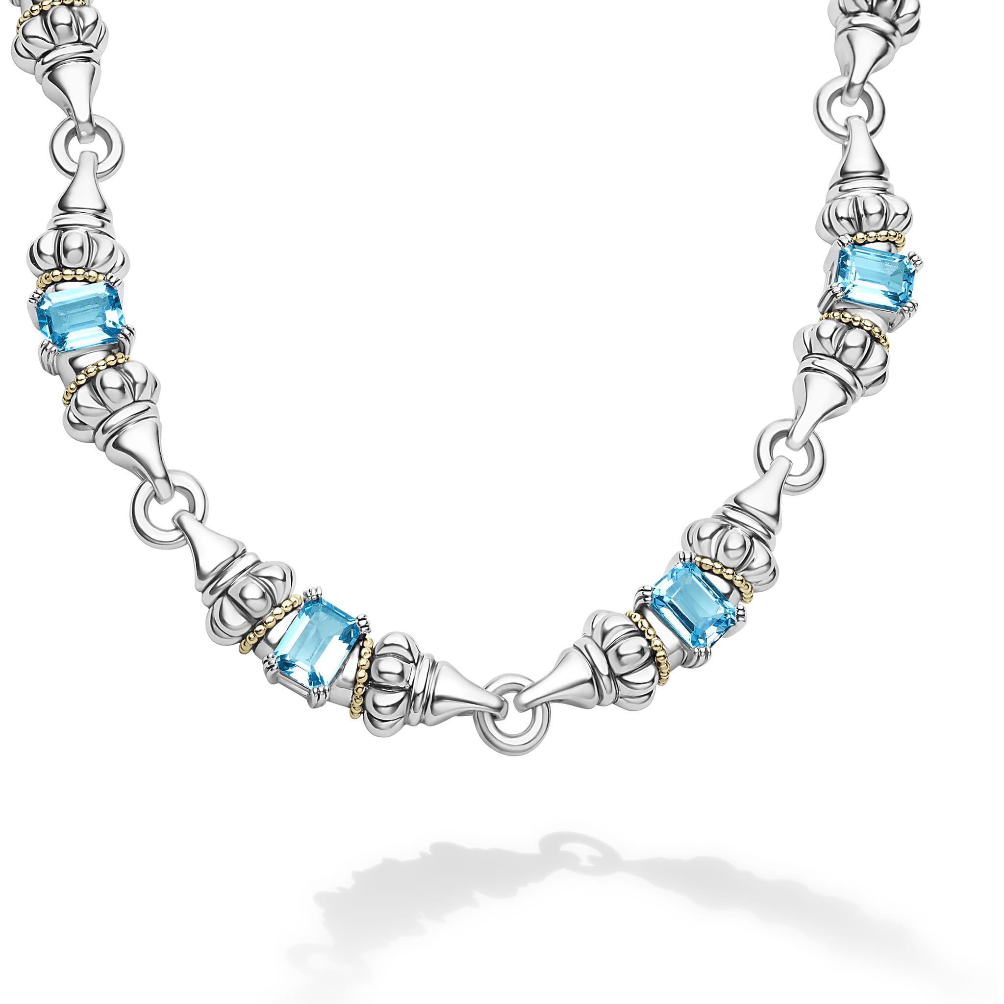 Ten emerald-cut swiss blue topaz gemstones with a prong setting in sterling silver and 18K gold Caviar beading form this necklace.