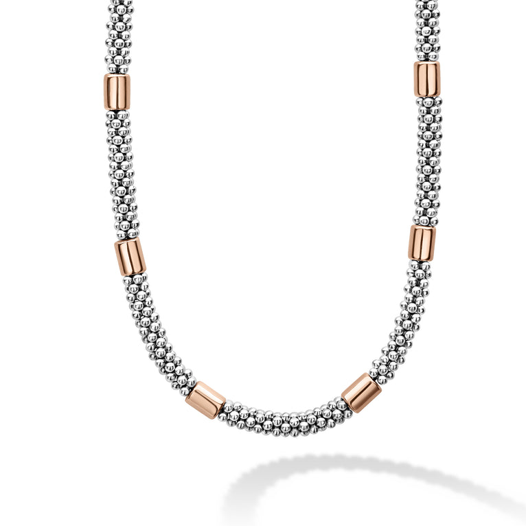 Six smooth stations of 18K rose gold and sterling silver surrounded by Caviar beading form this necklace.