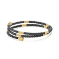 Black Caviar 18K Gold Small Station Ceramic Wrap Bracelet featuring coiled black ceramic beads with gold stations and polished gold endcaps, showcasing LAGOS craftsmanship.