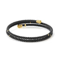 Black Caviar Ceramic Wrap Bracelet, featuring a sleek 3mm coiled design with polished 18K gold endcaps, showcasing modern refinement and versatile elegance.