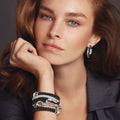 Young woman wearing Signature Caviar Oval Fluted Link Bracelet in polished sterling silver, showcasing smooth and fluted links on her wrist.