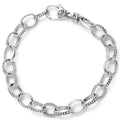 A sterling silver link bracelet alternating Caviar beading and smooth links.