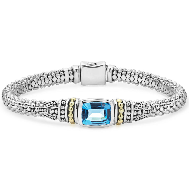Swiss blue topaz bezel-set gemstone and sterling silver Caviar beading with 18K gold detailing forms this bracelet.