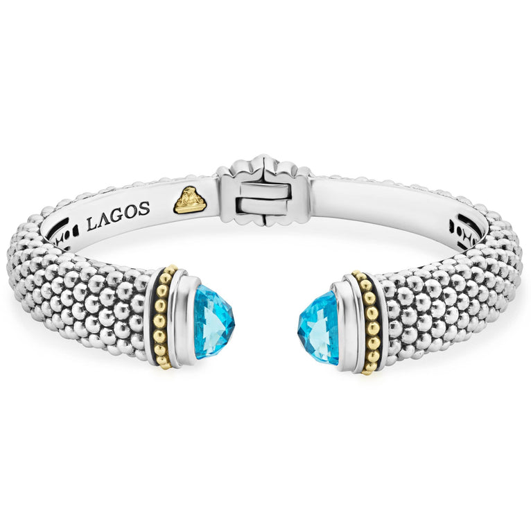 Expertly crafted Caviar beading with highly polished sterling silver stations comprise this innovative bracelet detailing swiss blue topaz gemstone end caps. Finished with a hinge clasp.