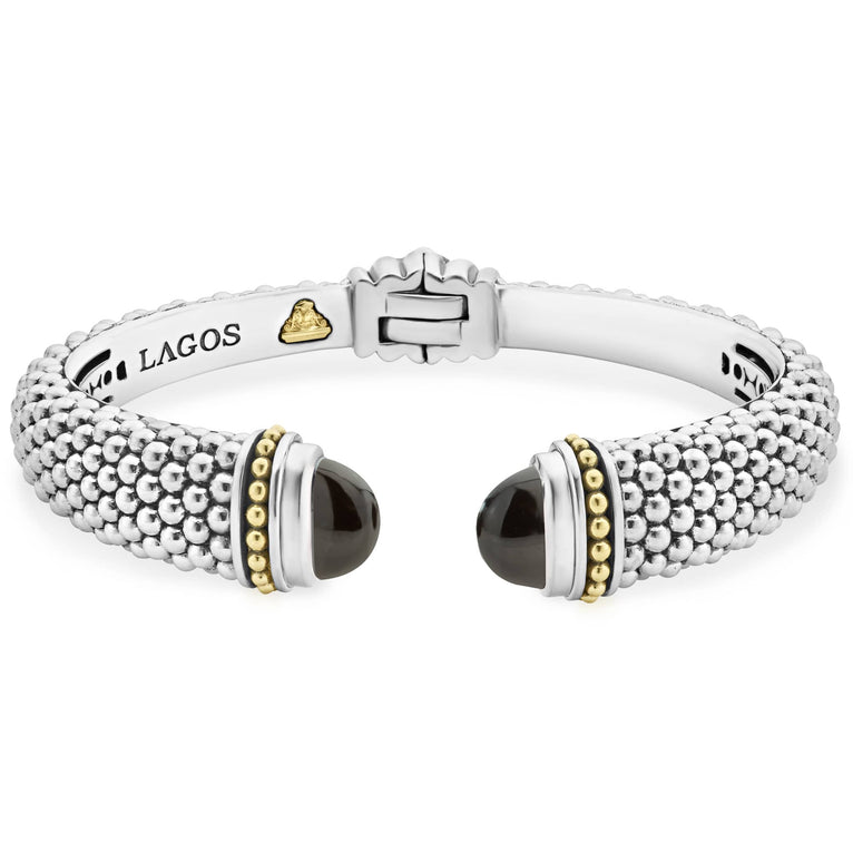 Expertly crafted Caviar beading with highly polished sterling silver stations comprise this innovative bracelet detailing onyx gemstone end caps. Finished with a hinge clasp.