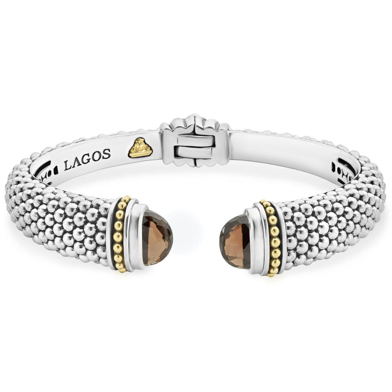 Expertly crafted Caviar beading with highly polished sterling silver stations comprise this innovative bracelet detailing smokey quartz gemstone end caps. Finished with a hinge clasp.