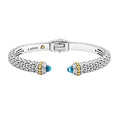 Caviar beading and highly polished sterling silver stations comprise this innovative cuff bracelet detailing swiss blue topaz gemstone end caps.