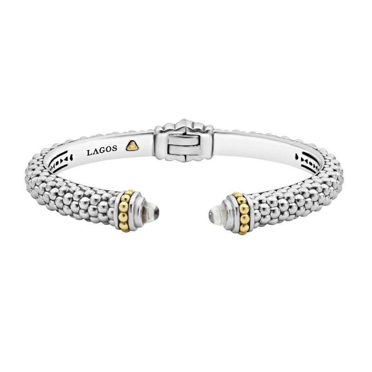 Caviar beading and highly polished sterling silver stations comprise this innovative cuff bracelet detailing white topaz gemstone end caps.