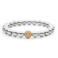 A highly polished sterling silver bracelet with a 18k Rose Gold Caviar beaded accent.