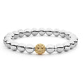 A highly polished sterling silver bracelet with a 18K gold Caviar beaded accent.