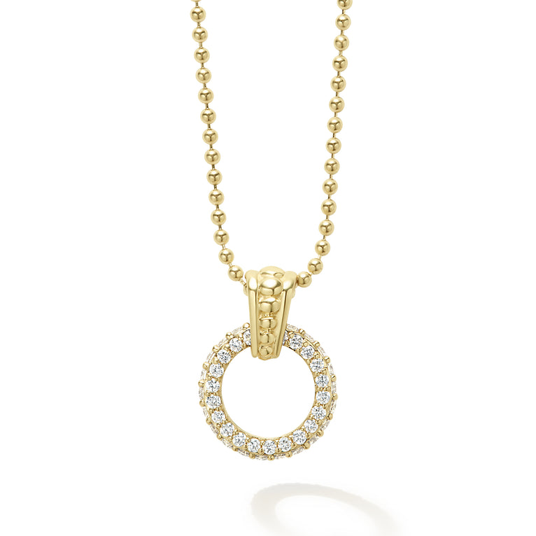 A diamond circle with an 18k gold Caviar beaded accent forms this pendant on a gold necklace. LAGOS diamonds are the highest quality natural stones.