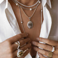 female model wearing Oval Pendant Necklace engraved with initials