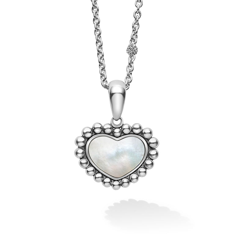 A mother of pearl gemstone pendant framed by sterling silver Caviar beading in the shape of a heart finished on an adjustable 16-18 inch necklace.