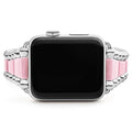 Smart Caviar Pink Ceramic and Stainless Steel Watch Bracelet for 42-49mm Apple Watch, featuring alternating polished steel and pastel-pink ceramic links, with visible digital crown and side button.
