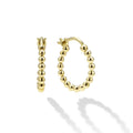 A LAGOS exclusive. Richly detailed 18K gold forms these signature Caviar beaded hoop earrings.