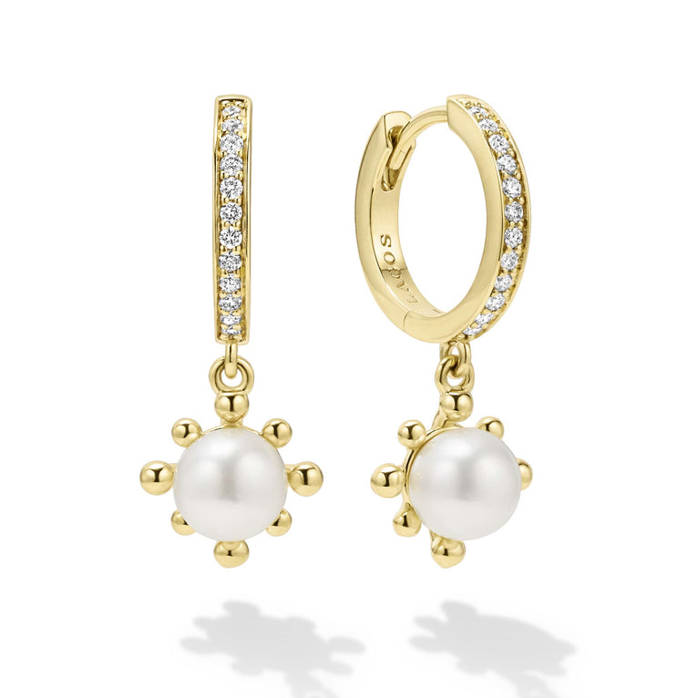 Cultured freshwater pearl drop huggie earrings framed by fleurs with diamonds set in 18K gold. LAGOS diamonds are the highest quality natural stones.