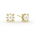 Sophisticated cultured freshwater pearl earrings framed by fleurs of 18K gold.