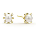 Sophisticated cultured freshwater pearl earrings framed by fleurs of 18k gold and diamonds. LAGOS diamonds are the highest quality natural stones.