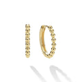 18K gold Caviar beading form these signature huggie earrings.