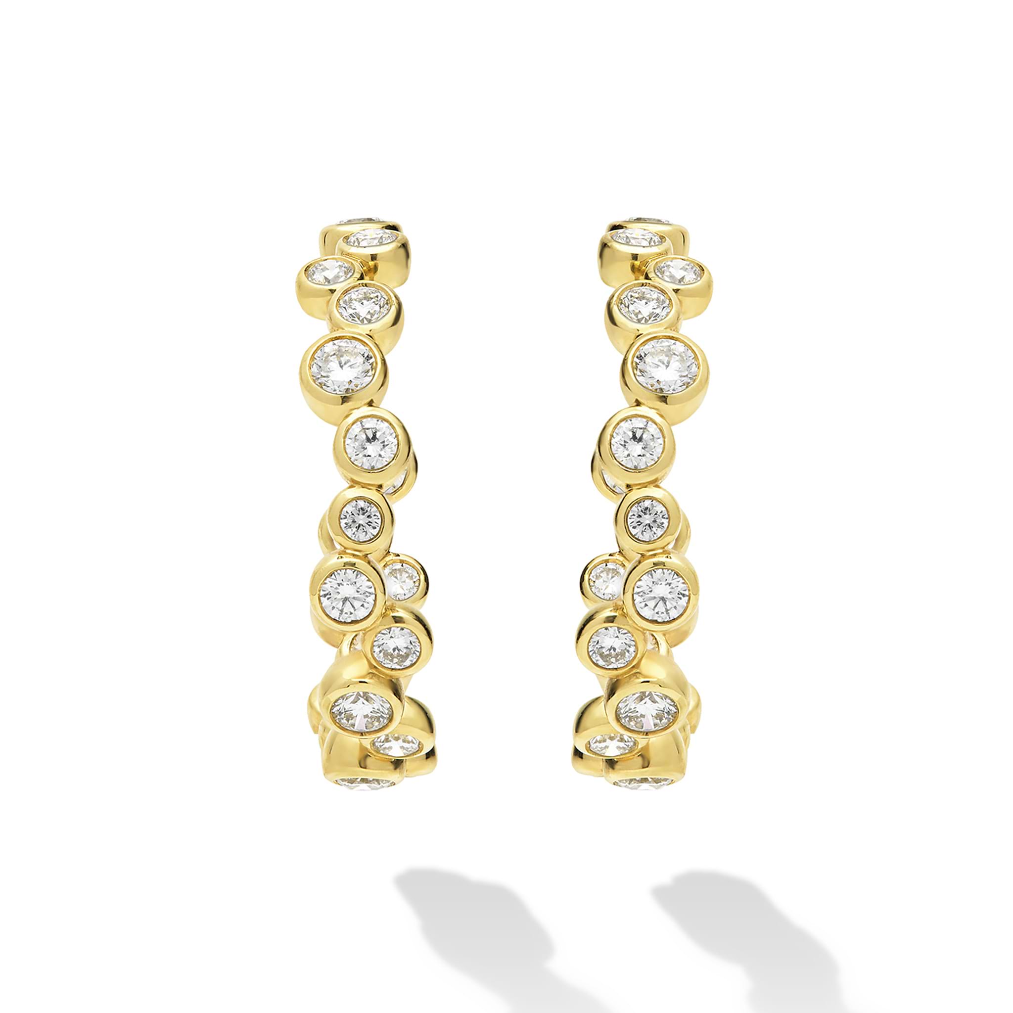 18K Gold hoop earrings with bezel-set diamonds on white background 