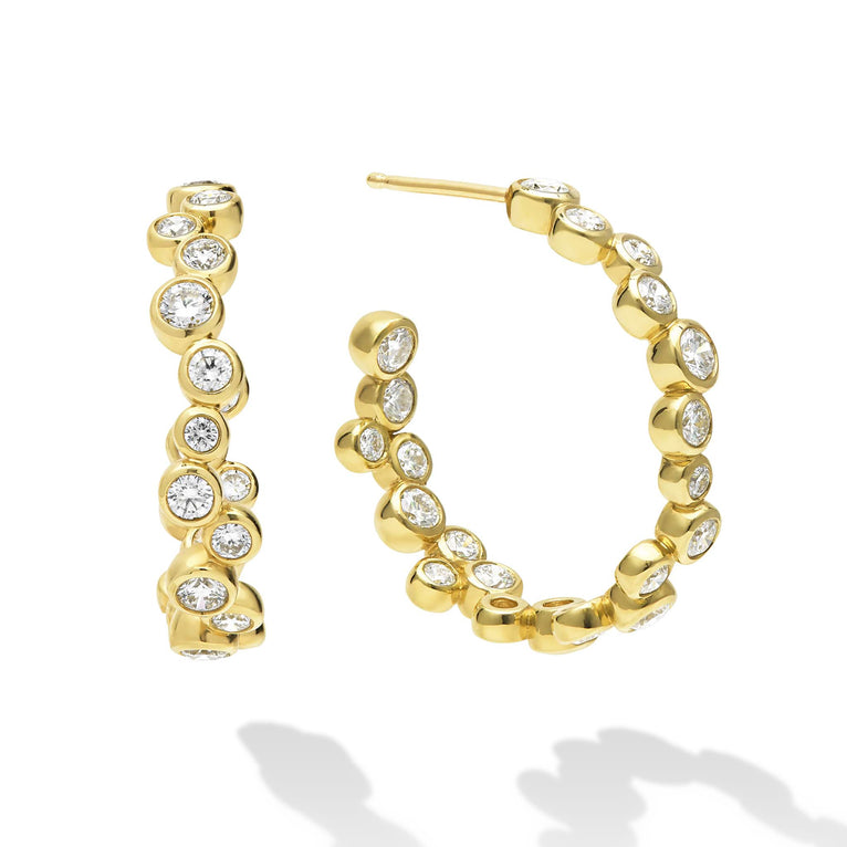 18K Gold hoop earrings with bezel-set diamonds and post back closure on white background 