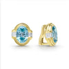 Smooth 18k gold and blue zircon gemstone accented by emerald cut diamonds form these oval shaped omega clip earrings. LAGOS diamonds are the highest quality natural stones.
