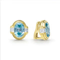 Smooth 18k gold and blue zircon gemstone accented by emerald cut diamonds form these oval shaped omega clip earrings. LAGOS diamonds are the highest quality natural stones.