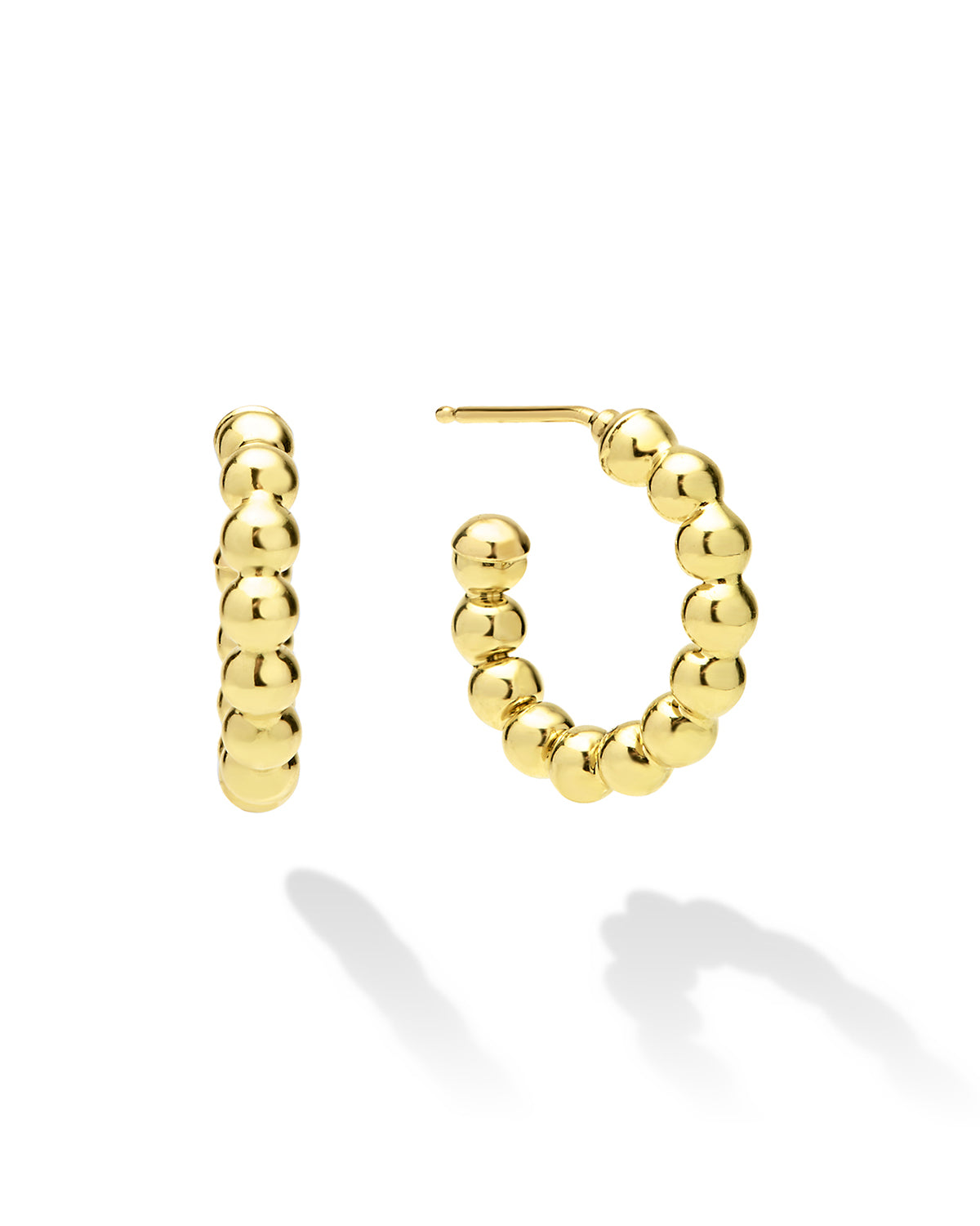 Gold hoop earrings with bead detailing on a white background