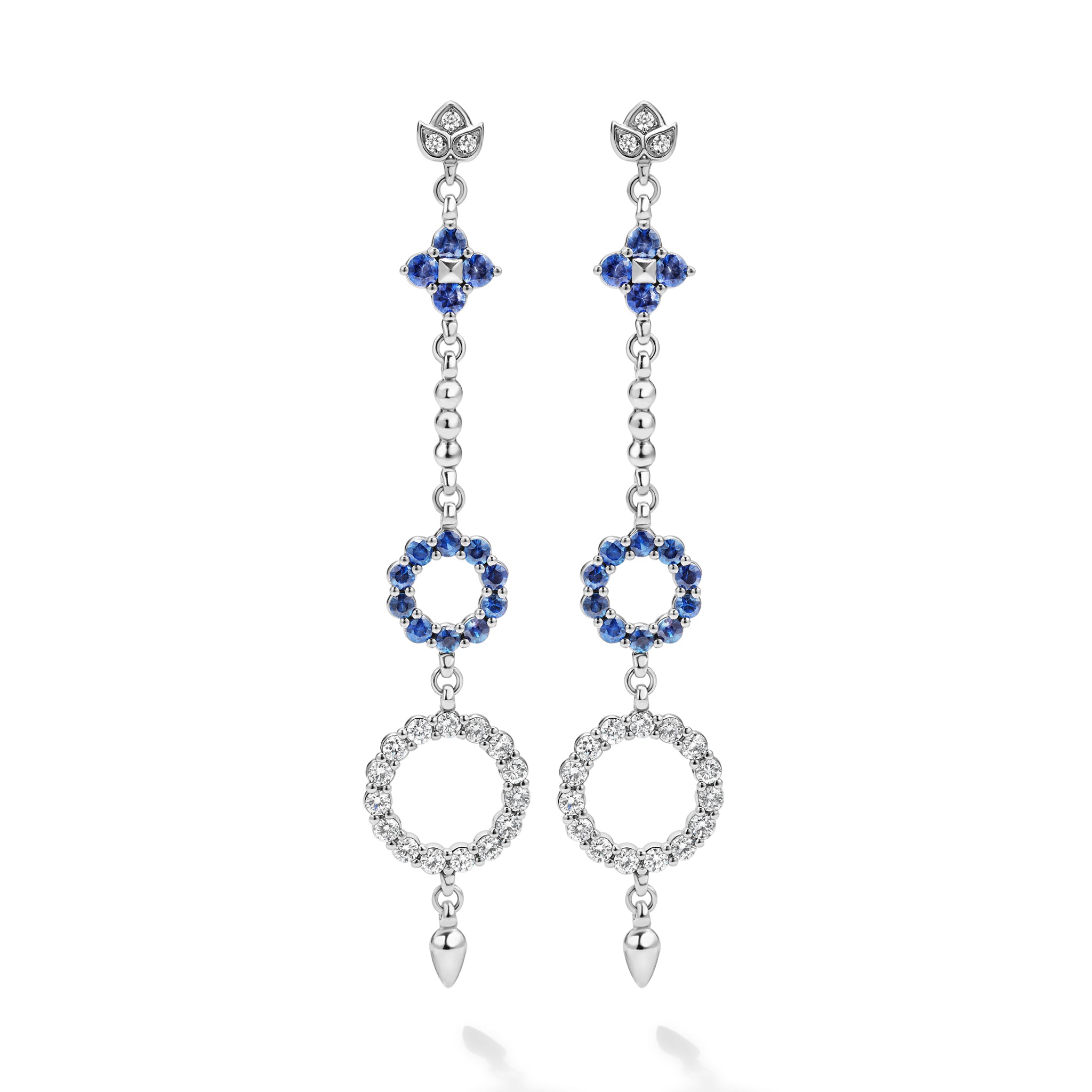 These earrings showcase a dazzling cascade of diamonds and blue sapphires, inspired by the delicate beauty of the lotus flower.
