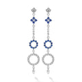 These earrings showcase a dazzling cascade of diamonds and blue sapphires, inspired by the delicate beauty of the lotus flower.