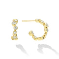 18K Gold huggie earrings with bezel-set diamonds and post on white background 
