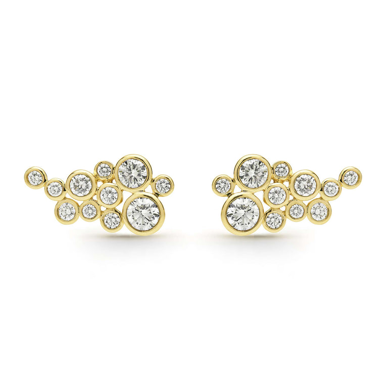 Eleven bezel-cut diamond stud earrings set in 18K gold on a white background