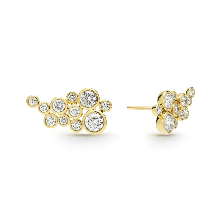 Eleven bezel-cut diamond stud earrings set in 18K gold with post on a white background
