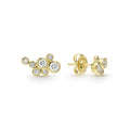 seven bezel-cut diamond stud earrings set in 18K gold with friction back closure on a white background