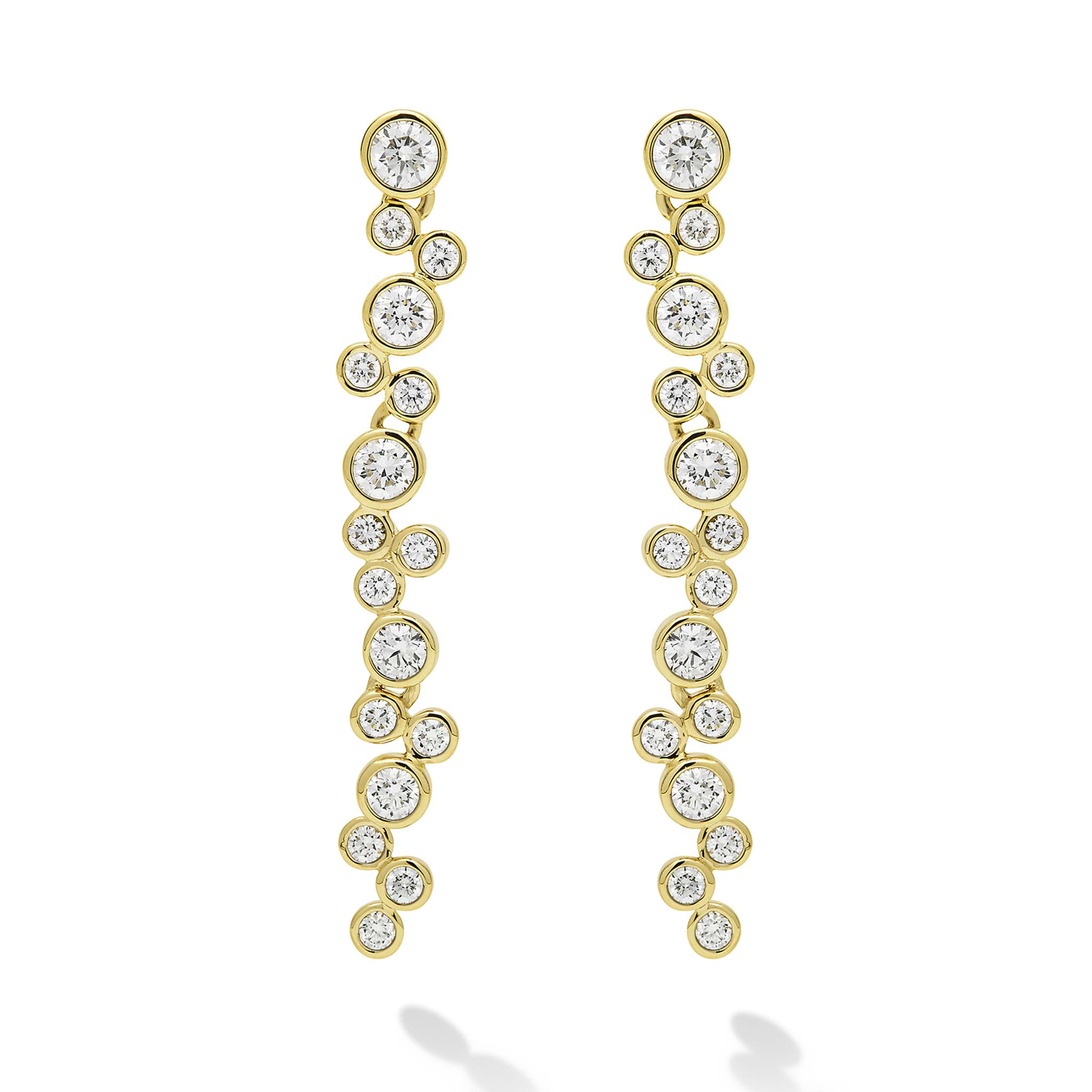 Seventeen bezel-cut diamond drop earrings set in 18K gold on a white background