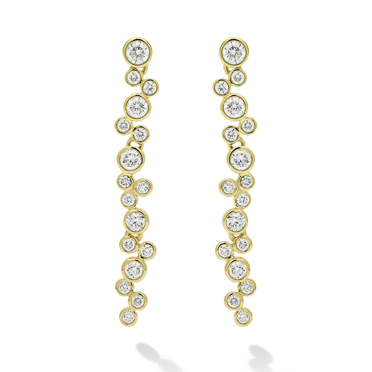 Seventeen bezel-cut diamond drop earrings set in 18K gold on a white background